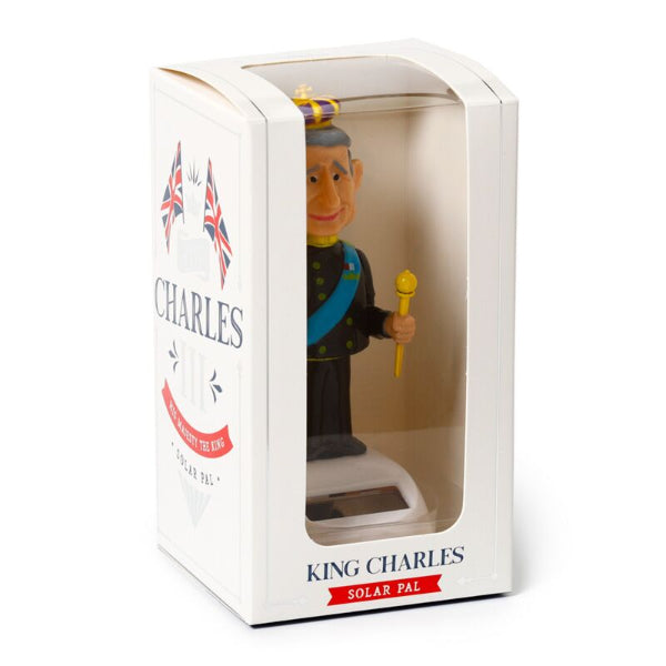 Figurine of King Charles in a packaging box with British flags on a white background