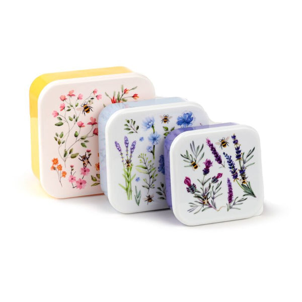Set of four small rectangular containers with floral designs on a white background