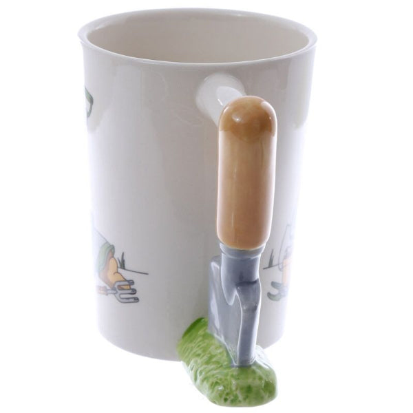 White mug with a garden trowel handle and cartoon design on a white background