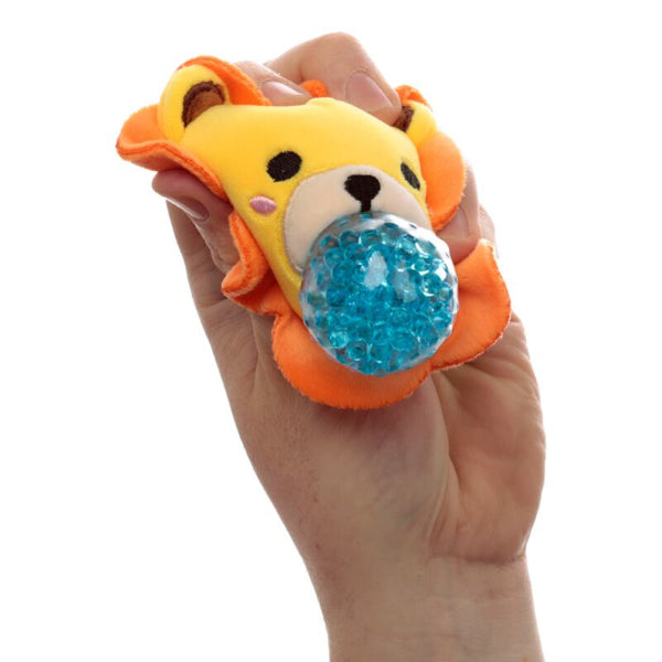 Hand holding a lion-shaped stress ball with a blue gel center against a white background