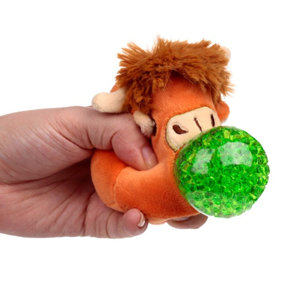 Hand holding a plush toy with a green ball in its mouth on a white background