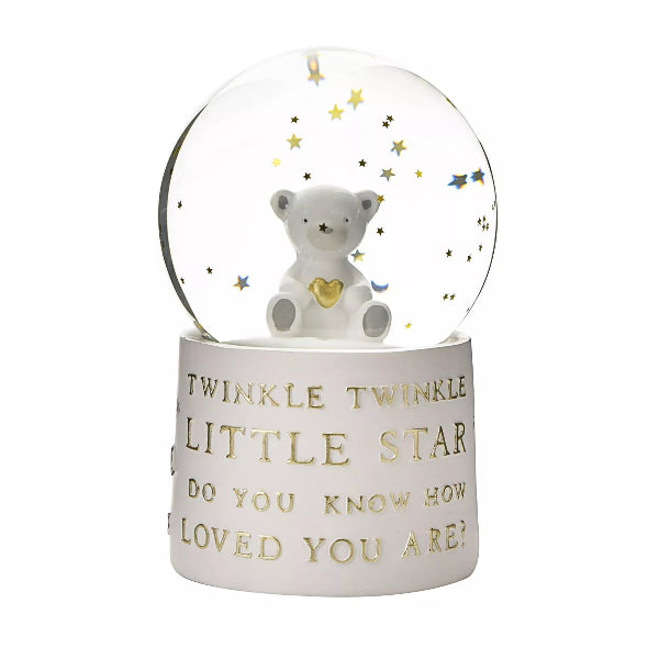 Snow globe with a bear figurine and text on a white background