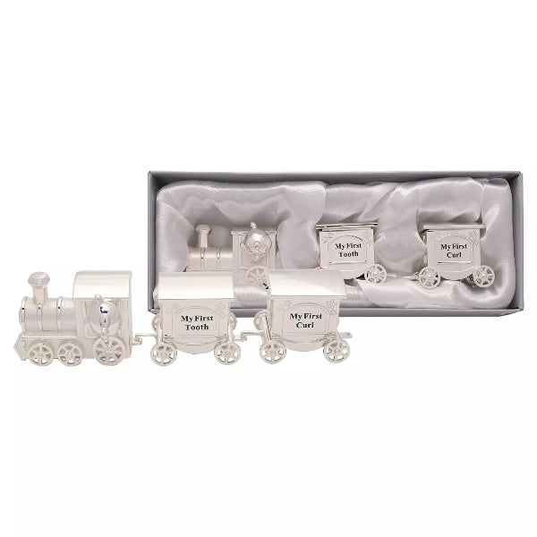 Silver train-themed baby keepsake set with 'My First' labels in a box on a white background