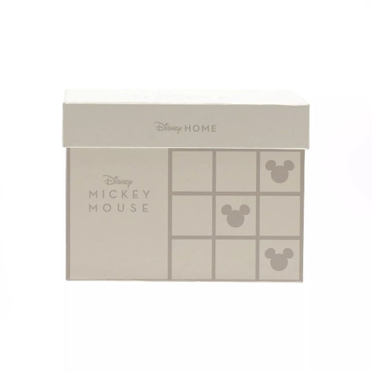 Beige packaging with Disney Home and Mickey Mouse branding on a white background
