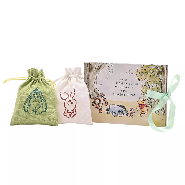 Set of three small bags with cartoon characters and a box featuring a classic children's illustration on a white background.