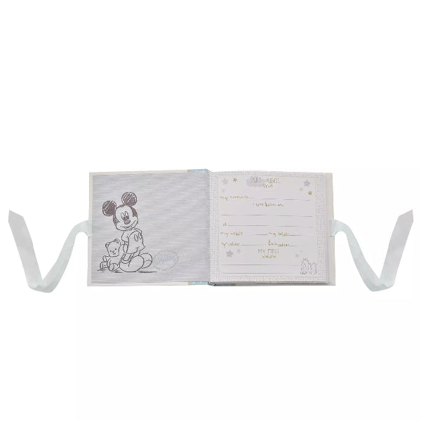 Open book with illustrations and text on a white background