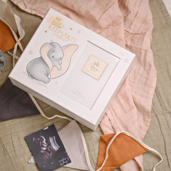 Baby keepsake box with Dumbo illustration on a soft fabric background