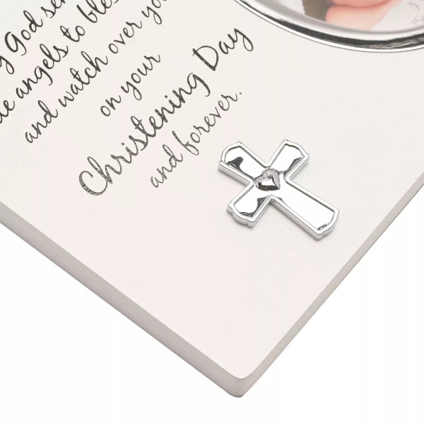 Silver cross charm on a white card with text