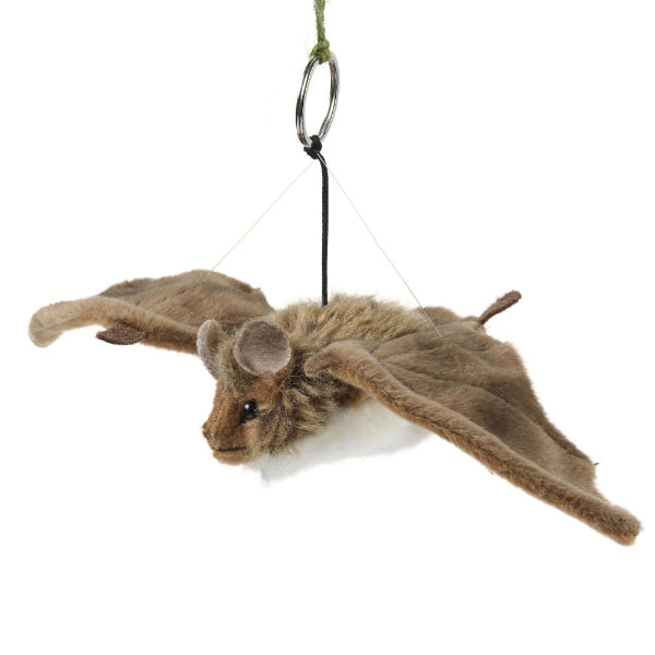 Plush toy resembling a flying squirrel hanging from a string on a white background