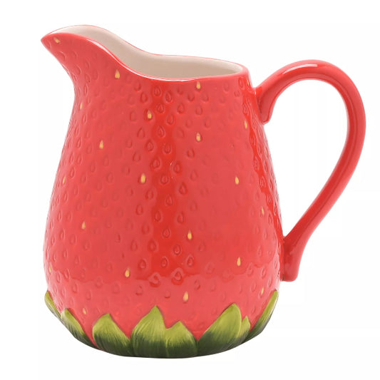 Red ceramic pitcher shaped like a strawberry on a white background
