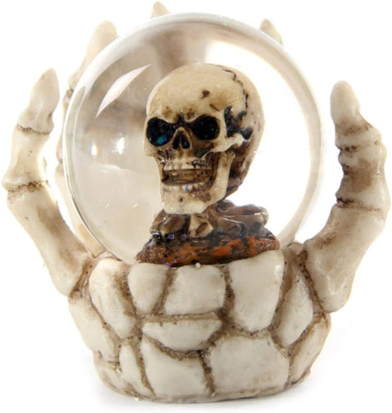 Decorative item with a skeleton hand holding a crystal ball on a white background.