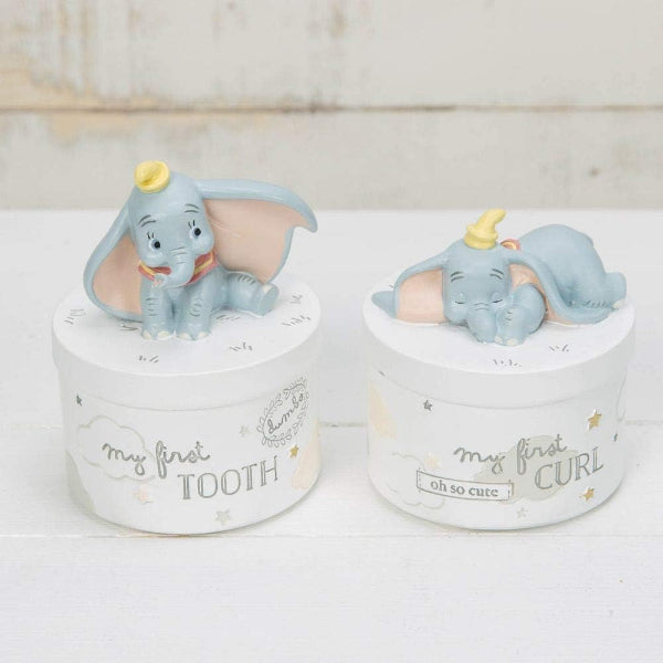 Two small containers with elephant figurines on a white surface