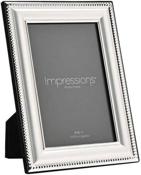 A 4x6 inch silver picture frame with a decorative beaded border and a black base, shown on a white background. The center insert displays the brand name 'Impressions'.