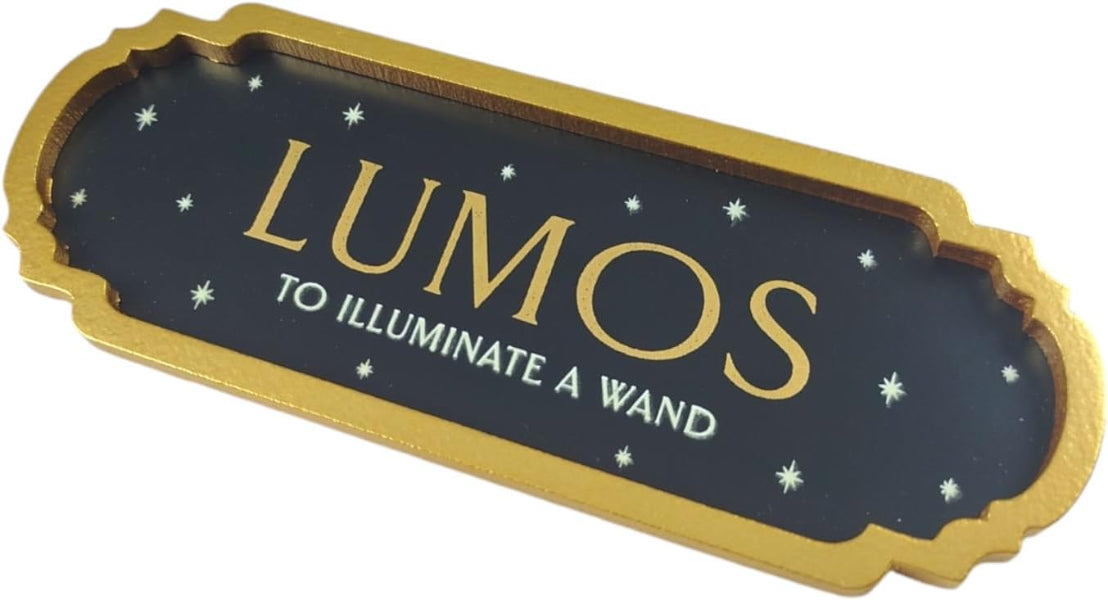 Decorative sign with 'LUMOS' text and gold border on a black background