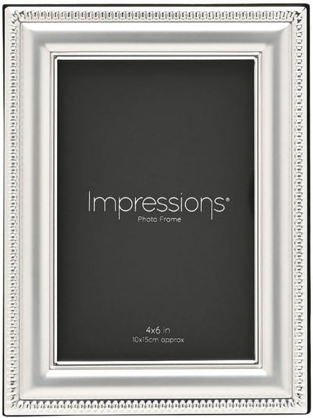 A silver picture frame with a decorative beaded border, shown against a dark gray background. The frame has the text 'Impressions Photo Frame' and '4x6 in / 10x15cm approx' printed on the insert.