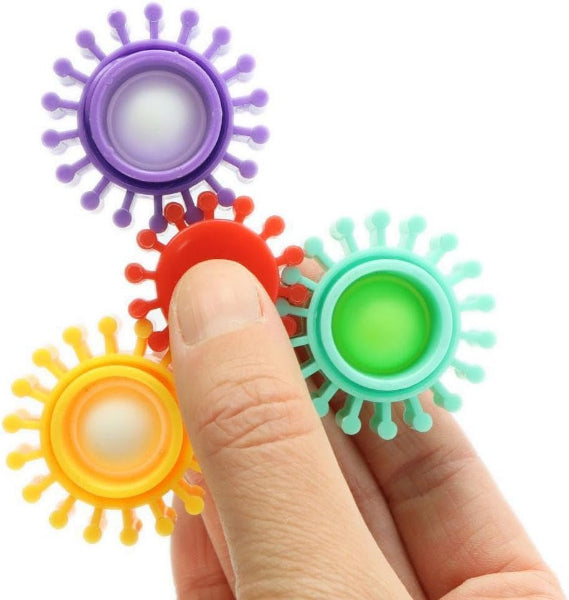 Colorful fidget spinners held by a finger on a white background
