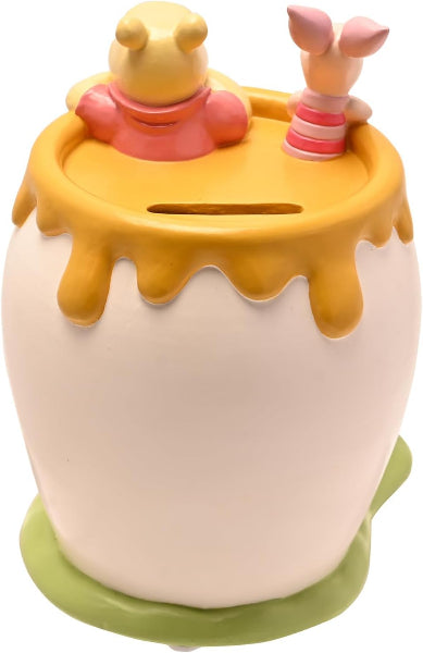 Sculpted piggy bank with cartoon characters on a white background