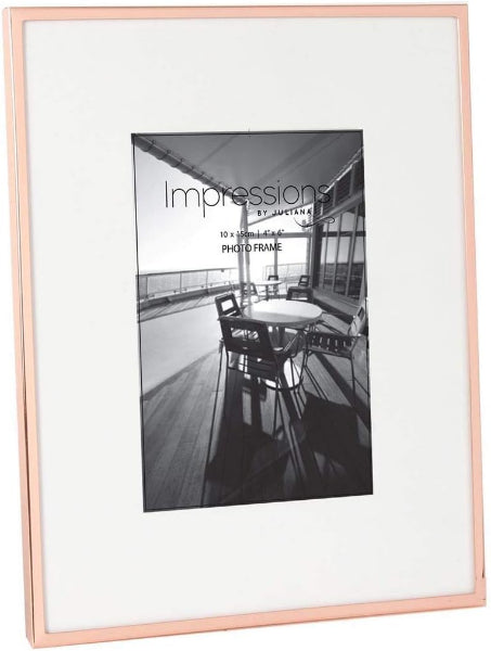 Rose gold photo frame with a black and white photo of a patio scene.