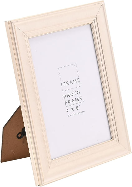 A 4x6 inch picture frame in a light cream or off-white finish, shown standing on its back with a brown backing board visible. The frame is photographed against a clean white background.