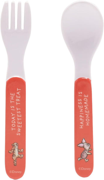 Children's cutlery set with pink handles featuring Disney characters on a white background
