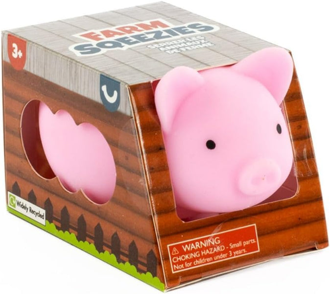 Pink pig toy in a wooden box packaging with 'Farm Soezies' branding.