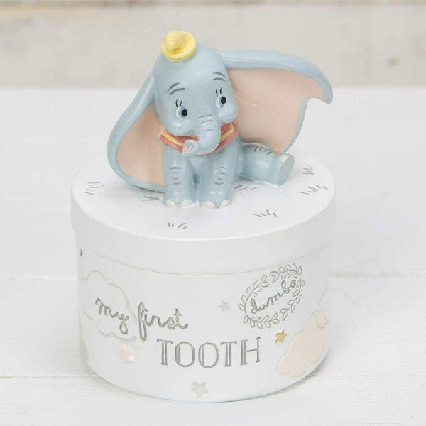 Decorative box with a small elephant figurine on top, labeled 'my first tooth'.