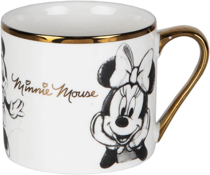 A white ceramic coffee mug with gold trim and a gold handle, featuring black and white illustrations of Minnie Mouse and her name in gold script.