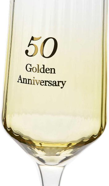 Champagne glass with '50 Golden Anniversary' text filled with white wine.
