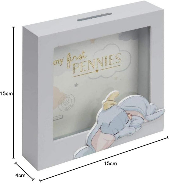 Children's piggy bank with Dumbo design and 'my first pennies' text, shown in packaging with dimensions.