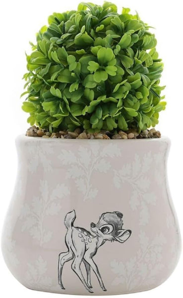 Small potted plant in a decorative pot with a cartoon character design on a white background