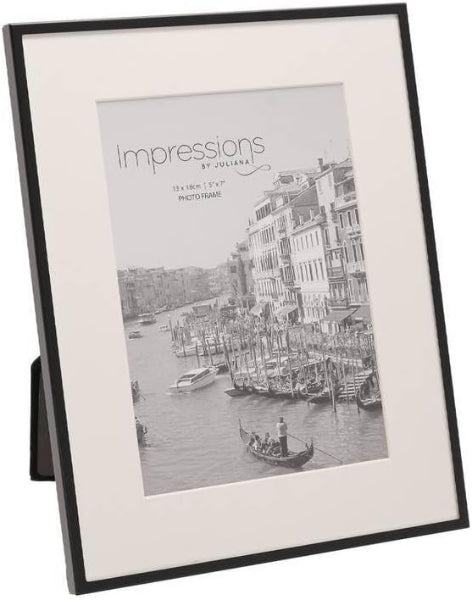 Framed black and white photo of a canal scene with boats and buildings