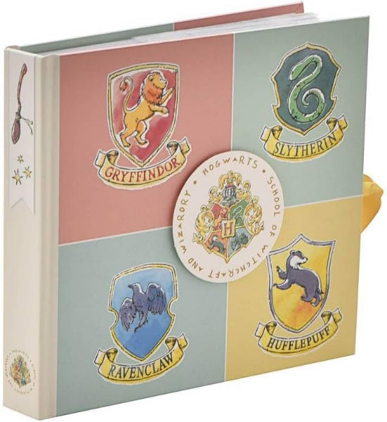 Book with Hogwarts house crests on a white background