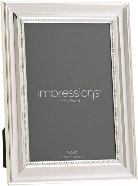 Silver photo frame with 'Impressions' branding on a gray background