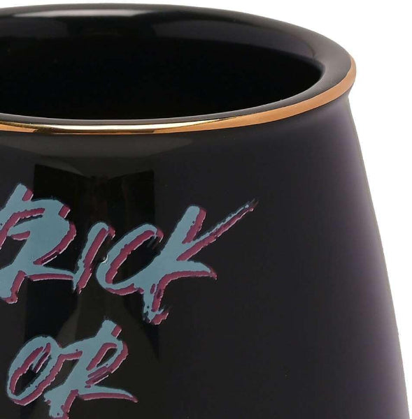 Black mug with 'Trick or Treat' text in pink and blue on a white background