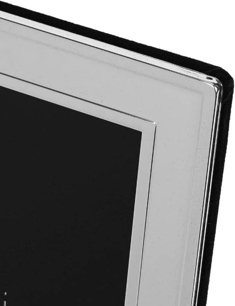 Close-up of a black rectangular object with a silver border on a white background