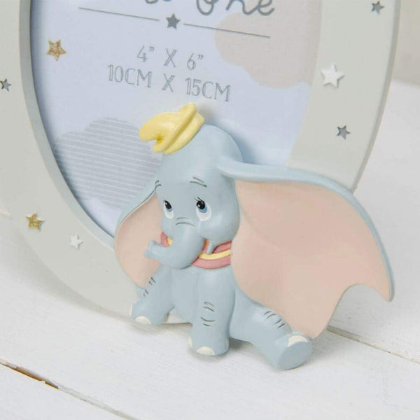 Small elephant figurine with a yellow hat on a white surface