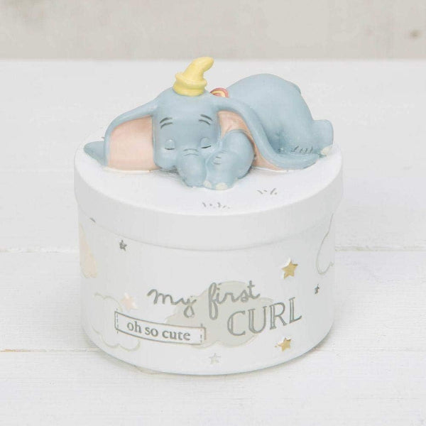 Baby toy elephant on a round white box with text