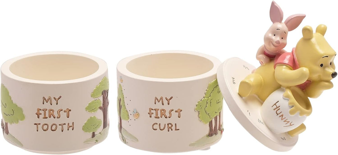 Two ceramic containers labeled 'My First Tooth' and 'My First Curl' with a Winnie the Pooh and Piglet figurine.