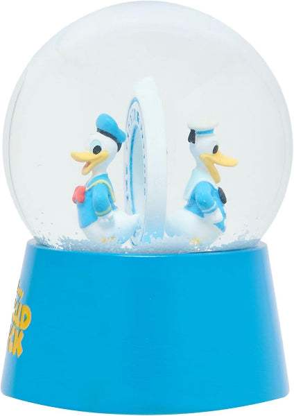 Snow globe with cartoon ducks on a blue base