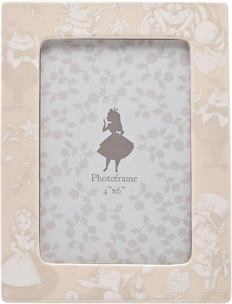 Decorative photo frame with floral design and 'Alice in Wonderland' silhouette on a white background