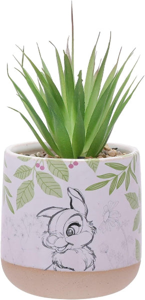 Potted plant with a decorative pot featuring a character and leaf pattern on a white background