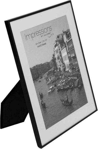 Framed black and white photograph of a canal scene with buildings and boats.
