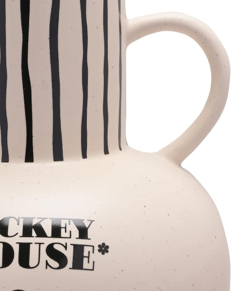Close-up of a ceramic mug with black text and striped pattern on a white background