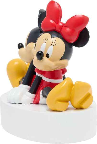 Minnie Mouse figurine with red bow and yellow shoes on a white base