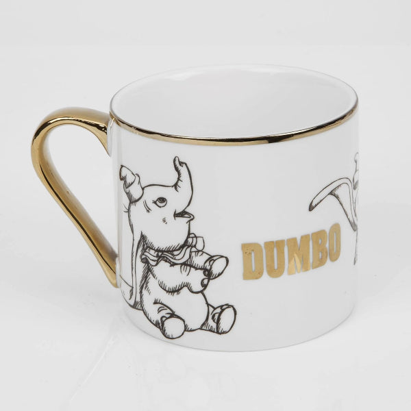 Mug with Dumbo illustration and gold accents on a white background