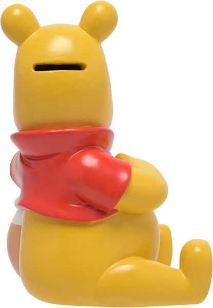 Yellow bear figurine with a red scarf on a white background