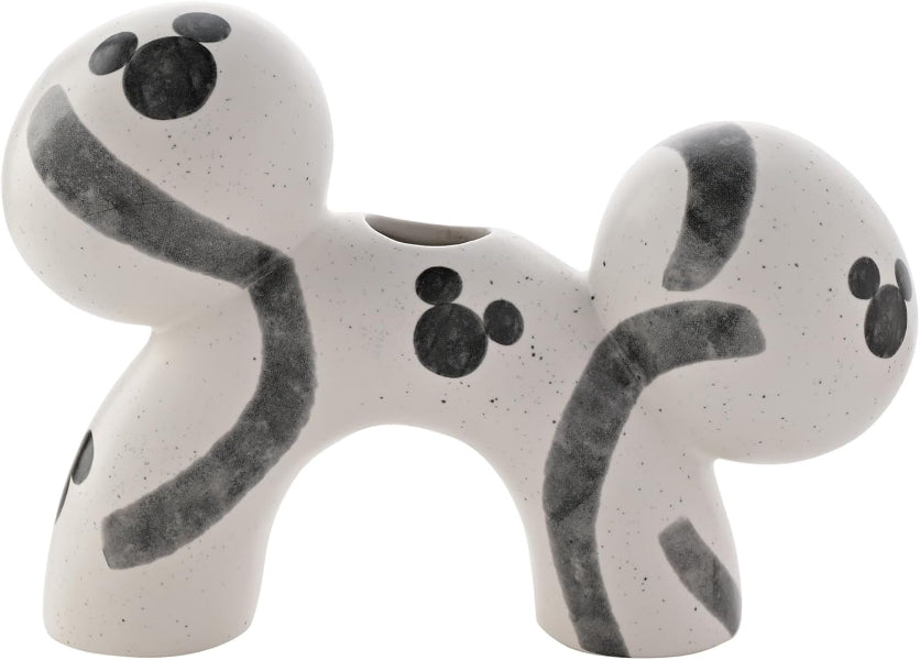 White ceramic dog toy with black paw prints on a white background