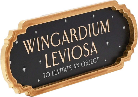 Decorative sign with 'Wingardium Leviosa' text on a black background with gold frame