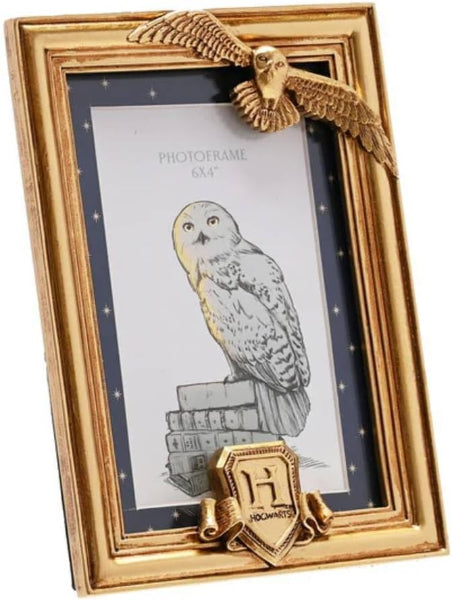Gold photo frame with owl design and Hogwarts crest on a white background