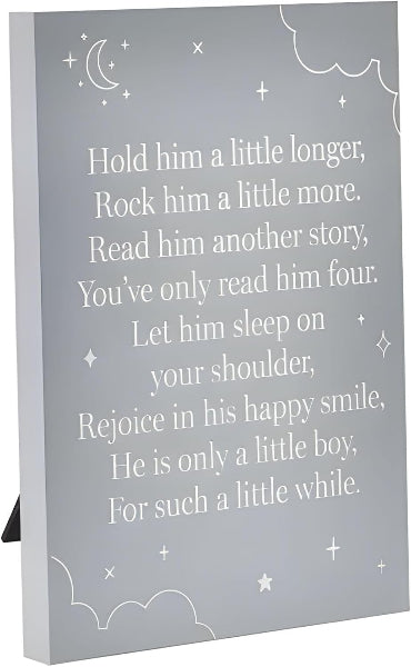A gray wooden baby nursery sign with white text reading 'Hold him a little longer, Rock him a little more. Read him another story, You've only read him four.